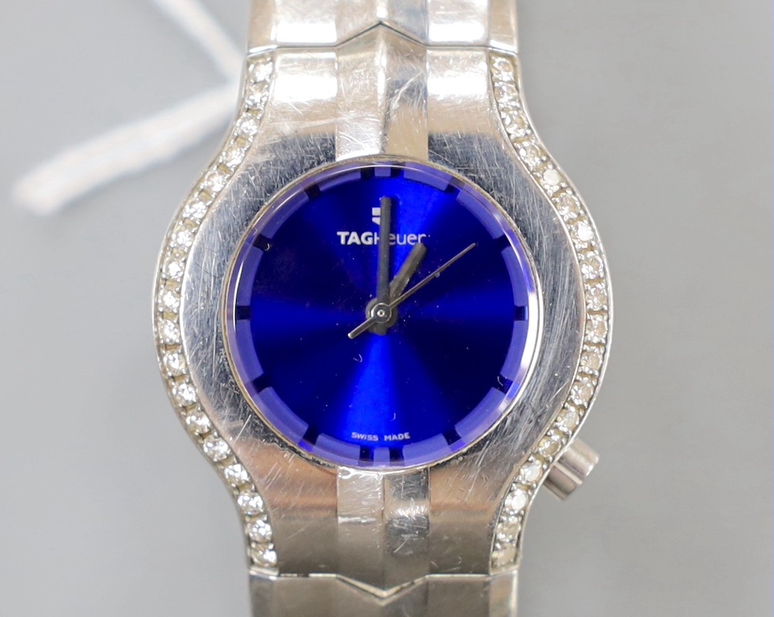 A lady's stylish modern steel Tag Heuer quartz wrist watch and bracelet, with blue dial and diamond chip set bezel, with boxes.